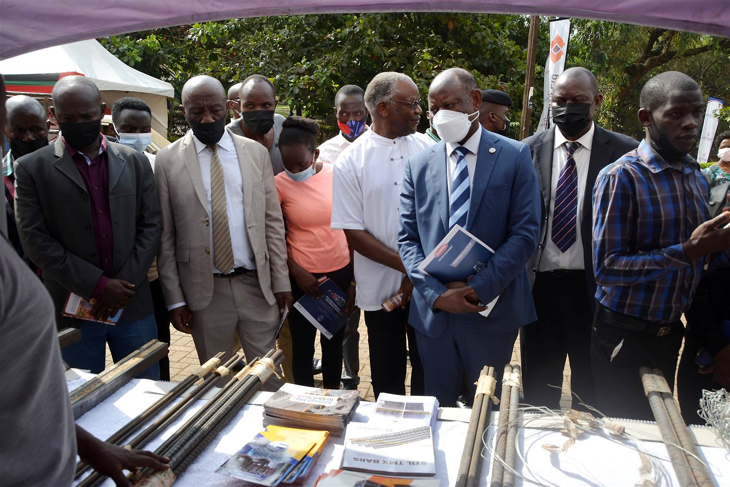 The Vice Chancellor, Prof. Barnabas Nawangwe (3rd R) flanked by the Principal CEDAT-Prof. Henry Alinaitwe (2nd L), Head Department Architecture and Physical Planning-Dr. Tamale Kiggundu Amin (2nd R), Architects and Fundis inspects one of the exhibition stands at the launch of the two-day training on 9th February 2022, CEDAT, Makerere University.