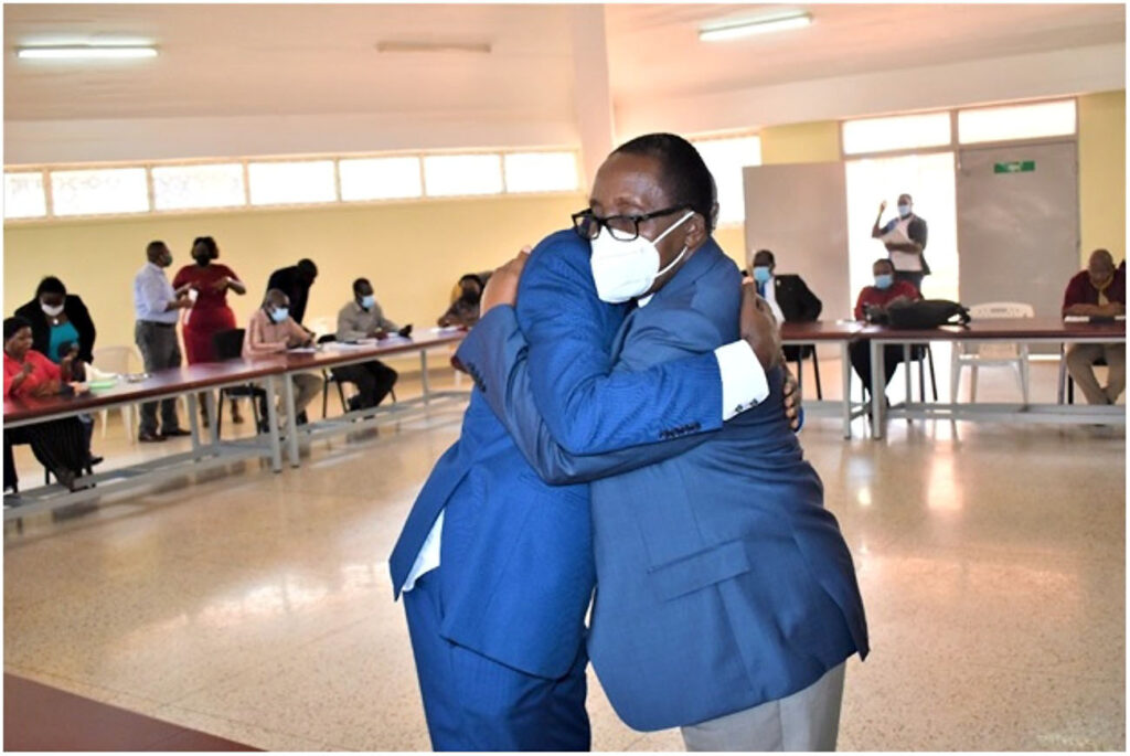 A hearty embrace by the Outgoing and Incoming Principal. 
