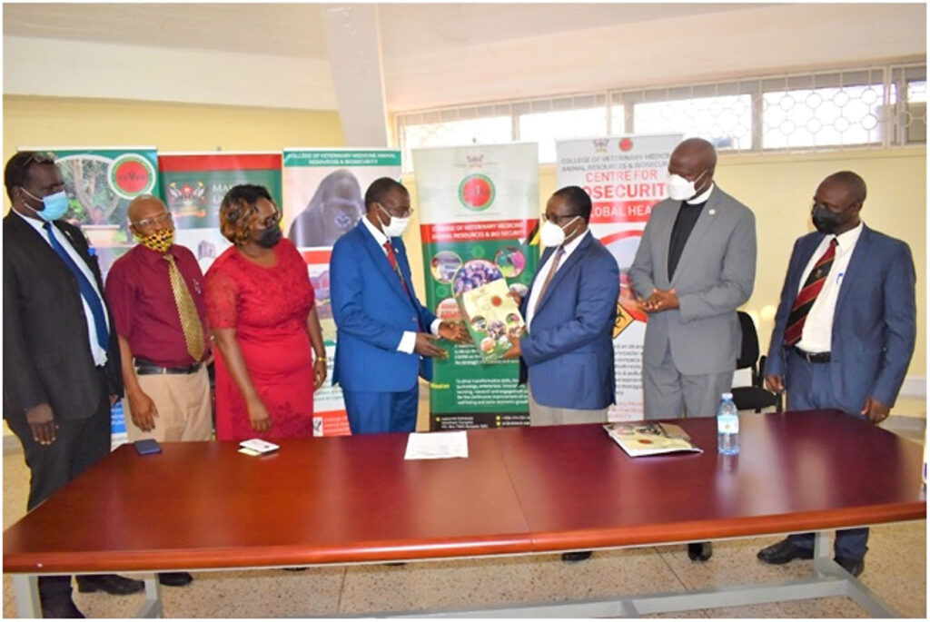 Prof. John David Kabasa (3rd R) hands over office to Prof. Norbert Frank Mwine (4thL).  The witnesses included the Chaplain St. Francis Chapel Rev. Onesimus Asiimwe (2nd R), Prof. Robert Tweyongyere (R). First from the Left is Mr. Walter Yorac Nono-Director Internal Audit, Mr. Julius Lebo from HR and Dr. Clare Mugasa, HOD..Photos by Juma Ssali.