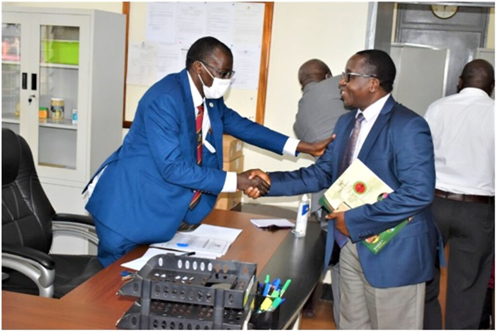 Prof. John David Kabasa (R) hands over the office to Prof. Norbert Frank Mwine (L).