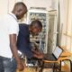 The installation team from DICTS configures one of the newly installed wireless Access Points (APs) during a network expansion project in February 2019.