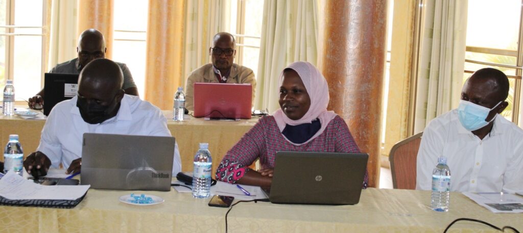 Assoc. Prof. Eria Hisali (R) and other participants attending the meeting before the official opening.