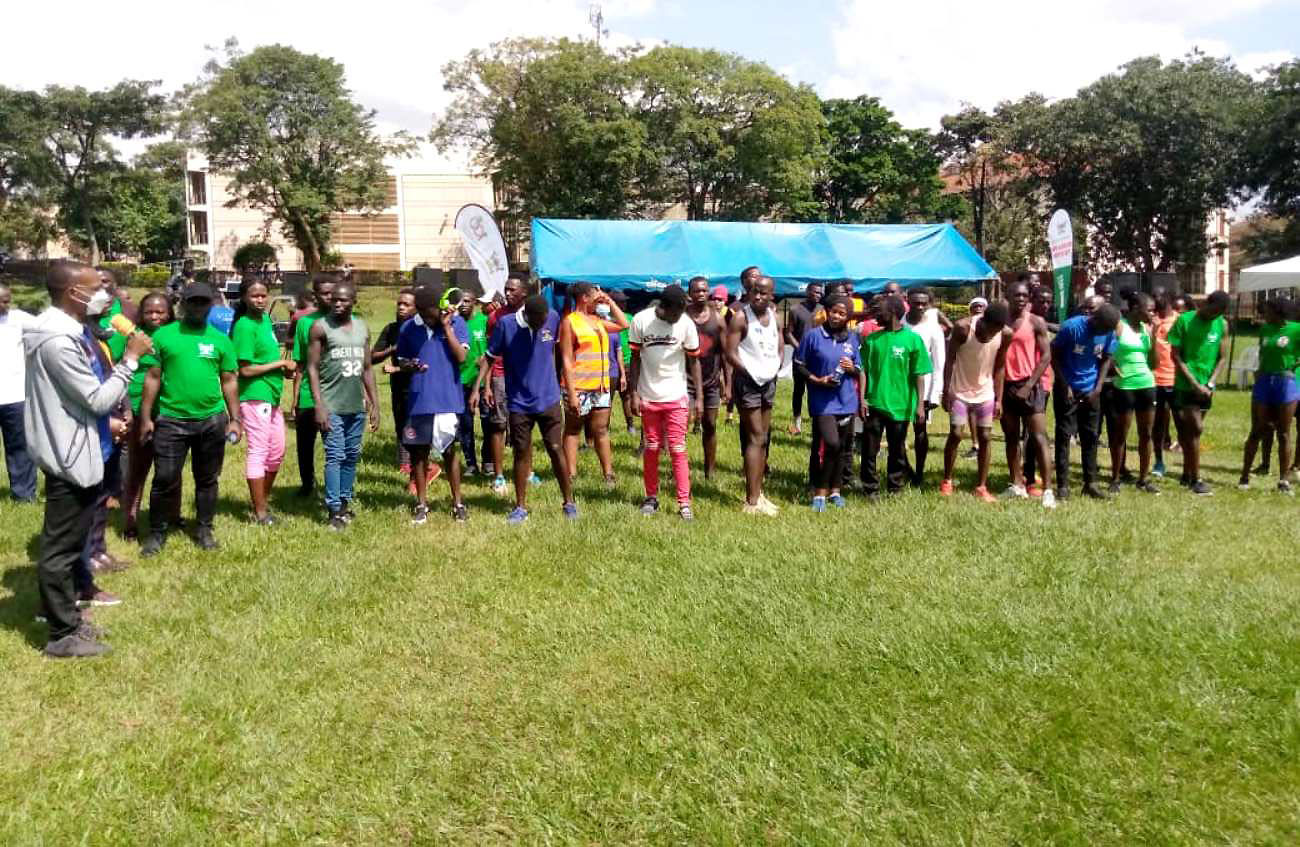 The Deputy Vice Chancellor (Academic Affairs), Prof. Umar Kakumba (L) flags off the Nkobazambogo Association mini-marathon at the Freedom Square, Makerere University on 27th February 2022.