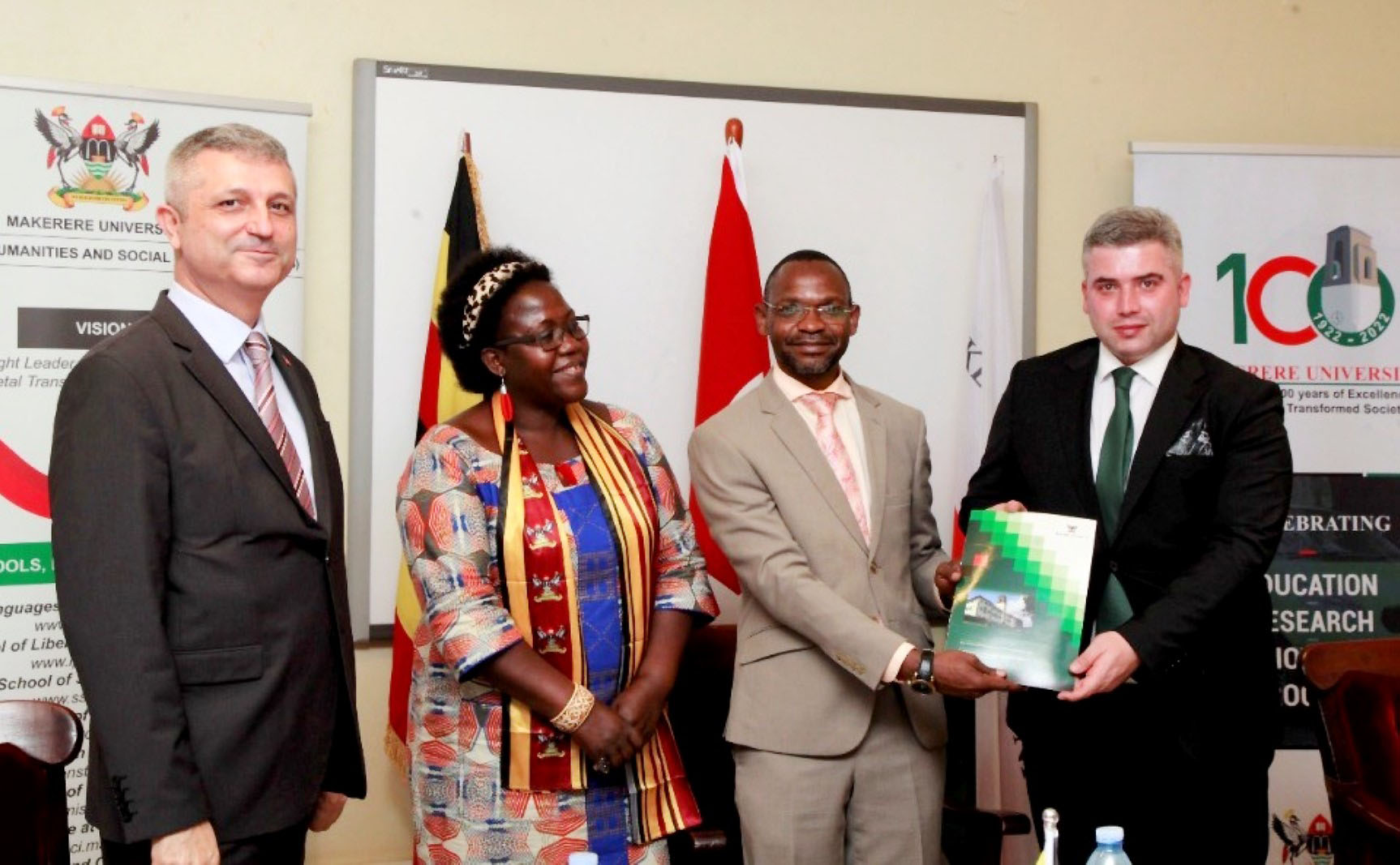 The DVCAA-Assoc. Prof. Umar Kakumba, Deputy Vice Chancellor (2nd R) and Dr. Abdullah Kutalmis Yalcin-Vice President Yunus Emre Institute (R) show of the signed MoU as Principal CHUSS-Assoc. Prof. Josephine Ahikire (2nd L) and another official witness on 25th February 2022, CTF1 Makerere University.