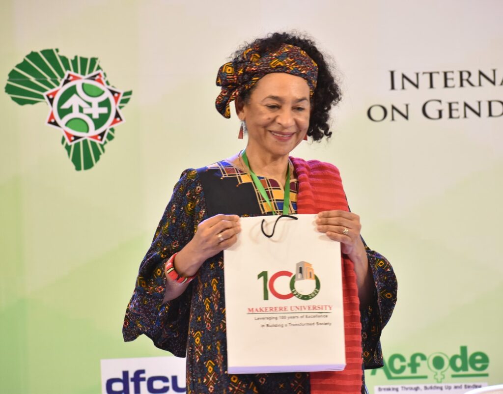 Prof. Amina Mama displays a gift presented to her after she delivered her keynote address.