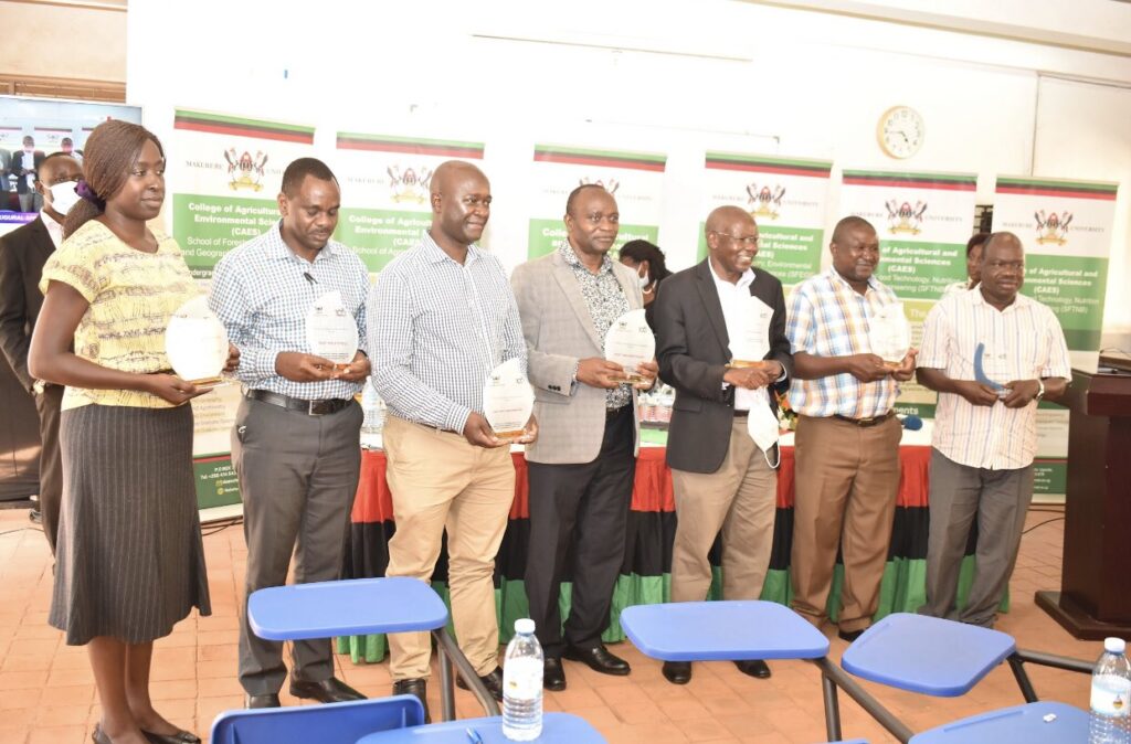 R-L: Dr. Mildred Ochwo-Ssemakula, Prof. Fred Babweteera, Dr. Yazidhi Bamutaze, Prof. Archileo Kaaya, Prof. Bernard Bashaasha, Prof. Nelson Turyahabwe and Dr. Gabriel Elepu pose with plaques during the event.