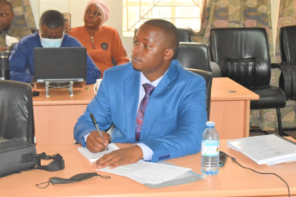 Dr. Kasimu Sendawula takes notes during his PhD Defence.