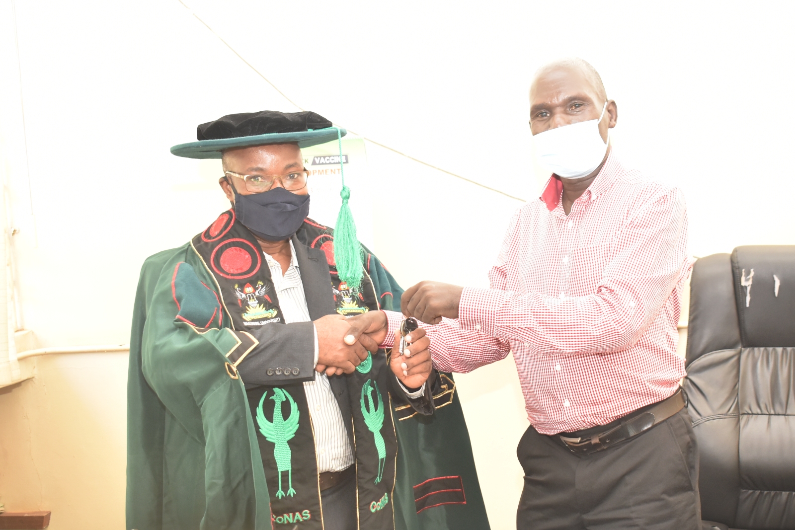 The outgoing Dean, Dr. Joseph Kyambadde (R) congratulating and handing over the keys to the Office of the Dean, School of Biosciences, College of Natural Sciences (CoNAS), Makerere University to Dr. Arthur K. Tugume (L) on 7th March 2022.