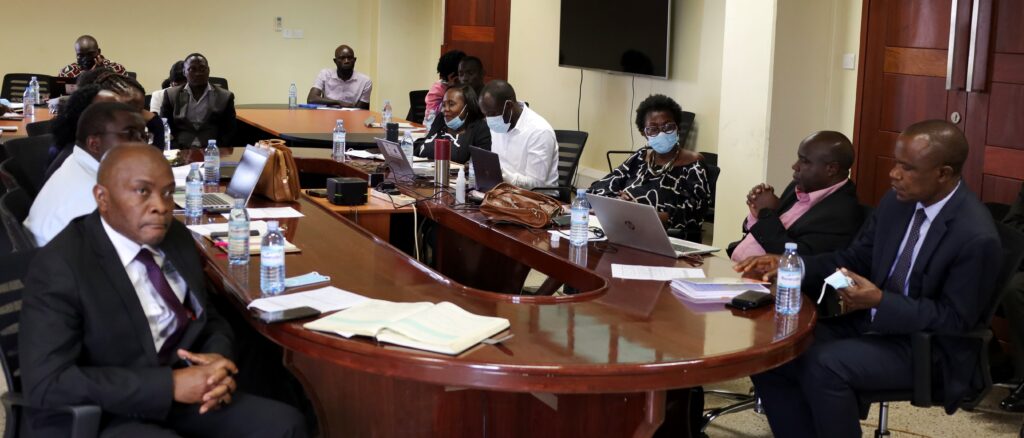 Assoc. Prof. Eria Hisali (R) and other workshop participants listen to the proceedings. 