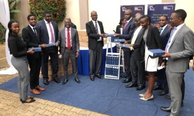The Principal School of Law-Prof. Christopher Mbazira (5th R) receives the donation from Managing Partner S&L Advocates-Mr. Barnabas Tumusingize as the firm’s leadership, staff and the President Makerere Law Society-Mr. Percy Mpindi (2nd L) witness on 18th March 2022.