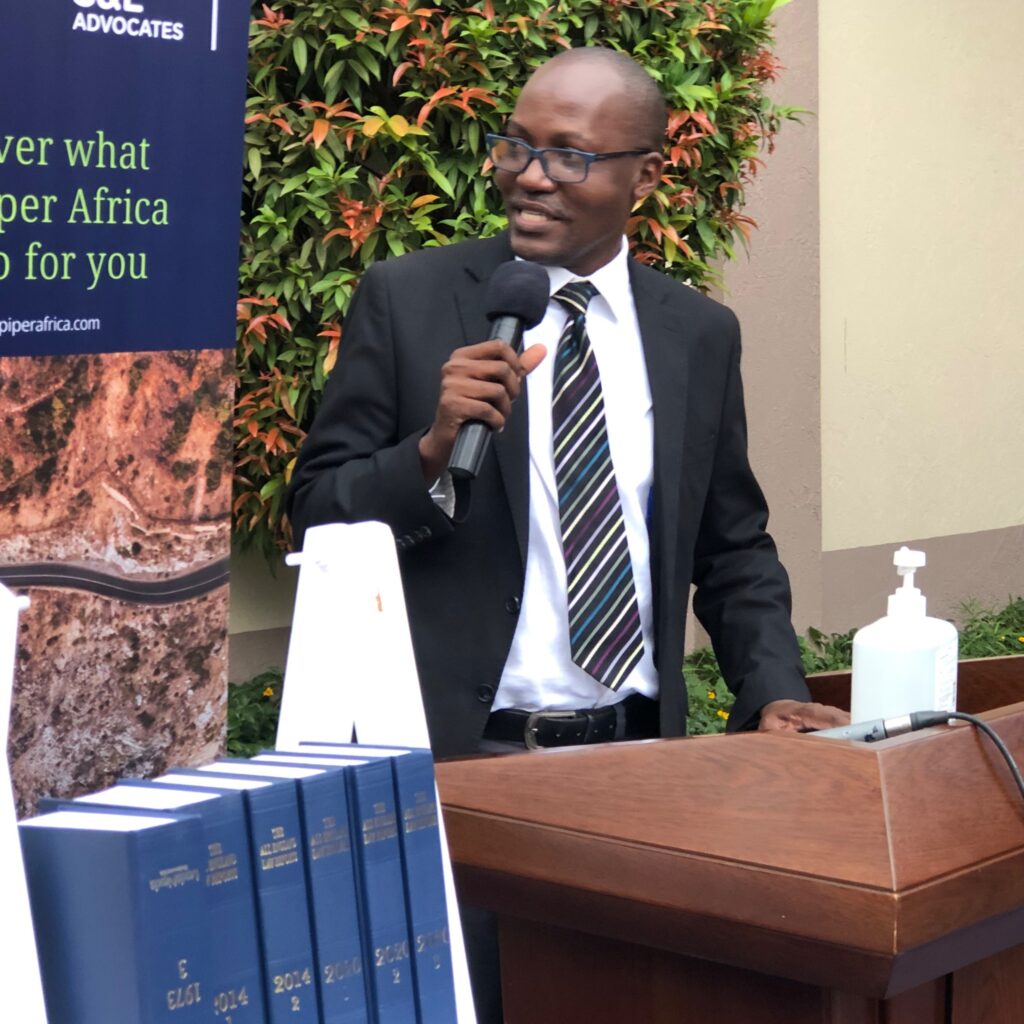 Prof. Christopher Mbazira, Principal School of Law, Makerere University with part of the donation of All England Law Reports (1936-2020) in the foreground. 