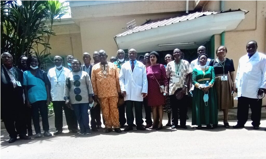 Prof. Josaphat Byamugisha (Centre in White Coat) with Makerere University Hospital Staff and Members of the Medical School Class of 1976 after their tour of the University Hospital premises.  (Photo by Alex Mugalu)