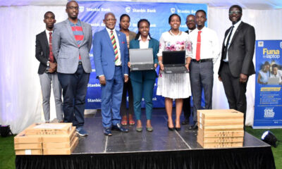 Vice Chancellor-Prof. Barnabas Nawangwe (3rd L), Guild President-H.E. Shamim Nambassa (C), Stanbic Bank Uganda Chief Executive-Ms Anne Juuko (4th R), Sam Mwogeza-Stanbic (R), Simon Nkuyahaga-HGZ Technologies (2nd L), Rt. Hon. Gatuya Mucyo (L) and other officials after the launch of the Laptop Loan Scheme on 10th Mar 2022.