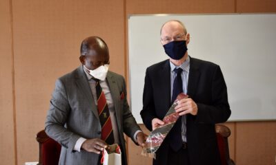 The Vice Chancellor, Prof. Barnabas Nawangwe (L) presents the Mak necktie and an assortment of souvenirs to WUN Executive Director, Dr. Peter Lennie (R) during his visit to Makerere University on 21st March 2022, Council Room, CTF1.