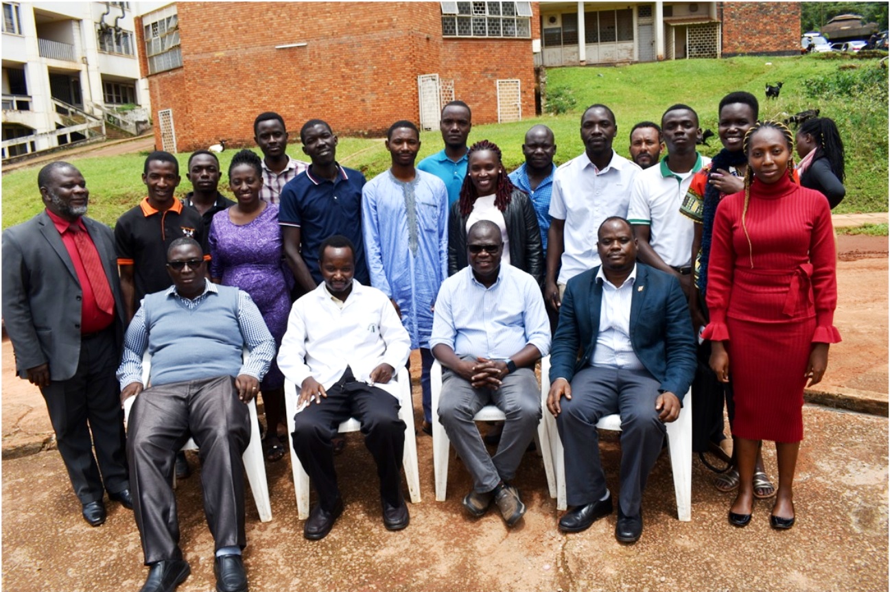 Participants in the multi-disciplinary training (Standing) with the trainers at The Carnegie African Diaspora Fellowship Program (CADFP) at College of Veterinary Medicine, Animal Resources and Biosecurity (CoVAB). Seated L-R are: Dr. Tamale Andrew, Collins Atuheirwe, Dr. Patrick Pithua – Virginia Polytechnic and State University and Assoc. Prof. Lawrence Mugisha from CoVAB, Makerere University in a group photo.