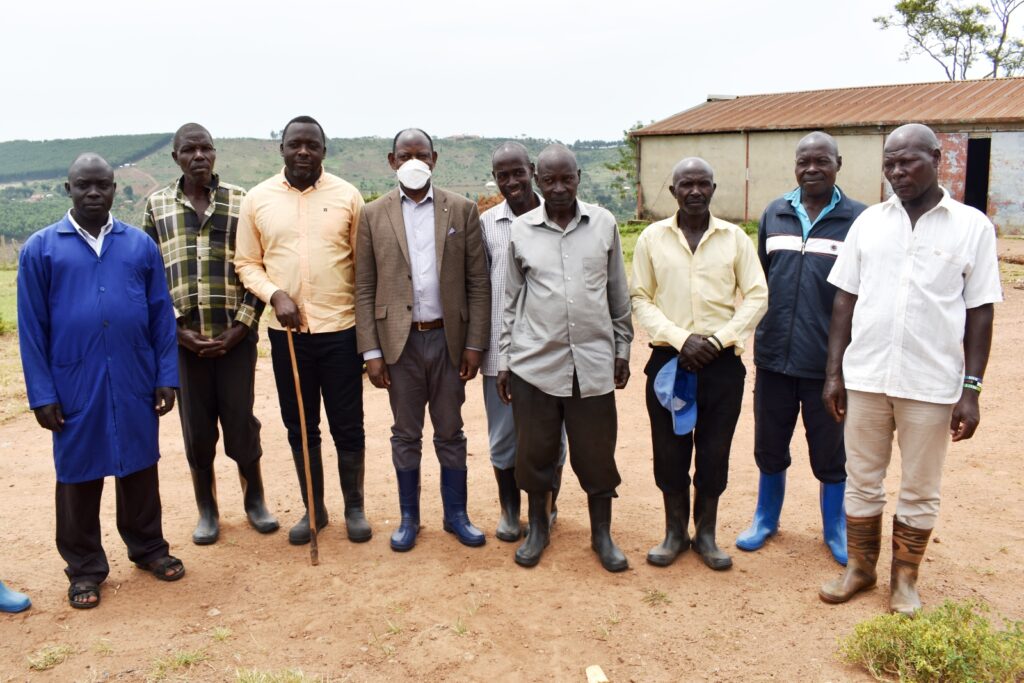 Prof. Barnabas Nawangwe (4th L) and Mr. Yusuf Kiranda (3rd L) pose for a photo with Buyana Stock Farm staff. 