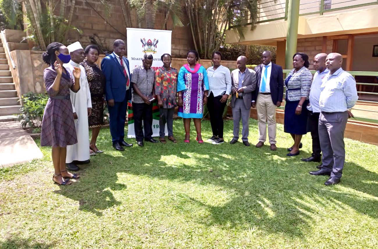 Participants in the Stakeholders' Consultative Meeting on the proposed Counselling and Guildance Policy pose for a group photo with the Facilitator Dr. David Onen (4th L) and Principal Investigator, Mr. Henry Nsubuga (4th R) on 1st April 2022.