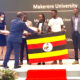 The State Minister for Higher Education, Hon. Dr. John Chrysostom Muyingo (2nd L) presents awards to the winning team; Rutanana Arnold, Nakyanzi Catherine and Nsengiyumva Wiberforce at the award ceremony in South Africa. (Courtesy Photo)