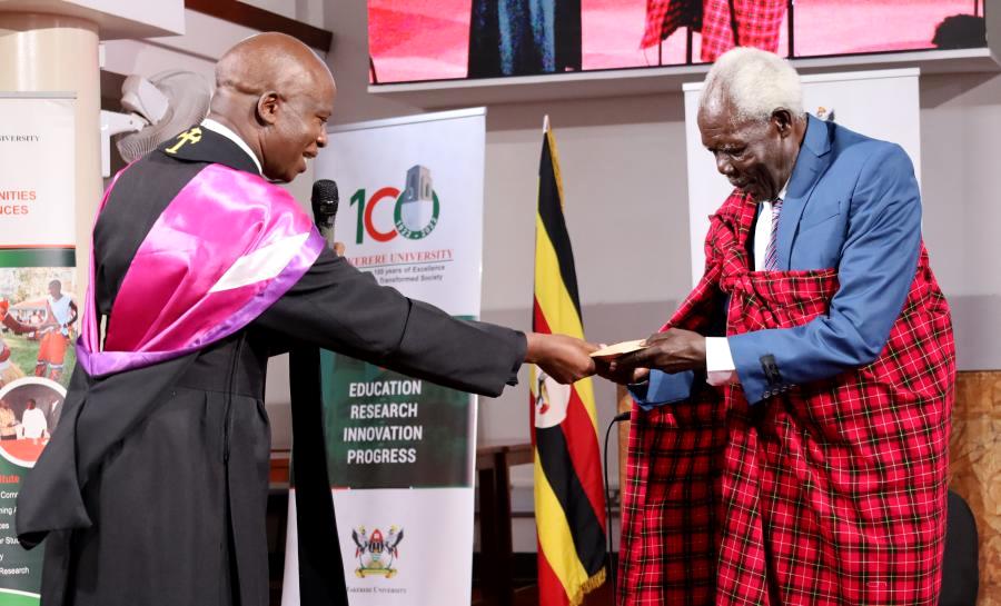 St. Francis Chaplain, Rev. Onesimus Asiimwe (Left) hands over the UGX 600,000 token to Mr. Zadok Adolu-Otojoka (Right).