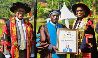 Mak Council Chairperson Mrs. Lorna Magara (R) hands over a framed certificate to Prof. William Bazeyo (C) in appreciation of his service to Makerere University, during the First Session of the 72nd Graduation on Monday 23rd May 2022 at the Freedom Square. Left is the Vice Chancellor Prof. Barnabas Nawangwe.