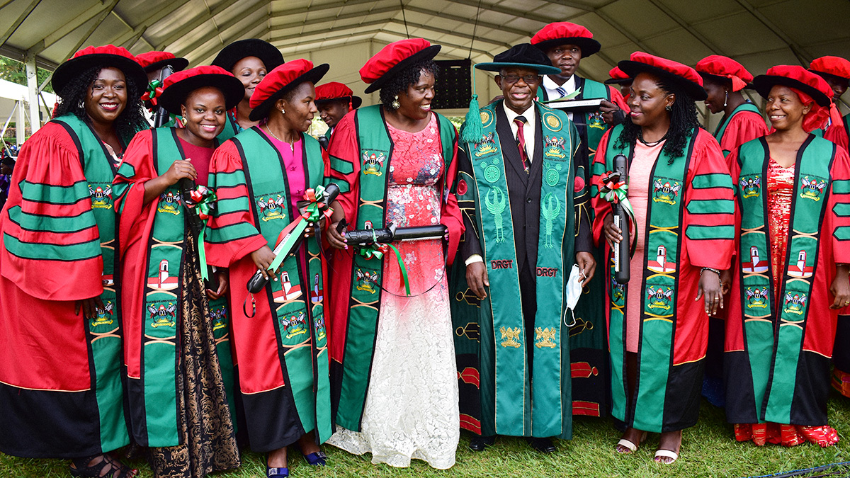 The Director, Research and Graduate Training (DRGT), Prof. Buyinza Mukadasi (Centre black cap) poses with some of the PhD Graduands from CHS, CoNAS and the School of Law during the First Session of Makerere University's 72nd Graduation Ceremony on 23rd May 2022.