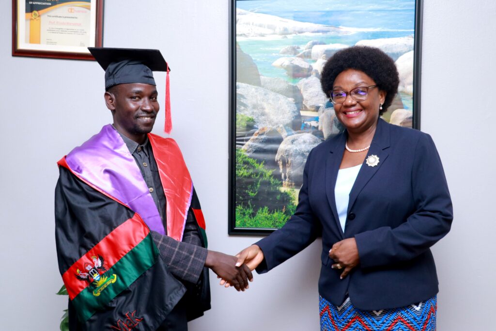 Dr. Rhoda Wanyenze, Professor and Dean MakSPH congratulates Arac Oscar on his first class. Photo-Davidson Ndyabahika