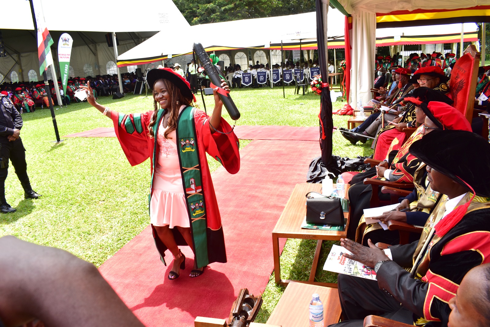 Dr. Nabawanda Olivia celebrates after graduating with a PhD in Mathematics at 31 years of age during the First Session of Makerere University's 72nd Graduation Ceremony on 23rd May 2022, Freedom Square.