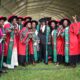 The Director, Directorate of Research and Graduate Training (DRGT), Prof. Buyinza Mukadasi (Centre Black Cap) congratulates the PhD graduands at the first session of the 72nd Graduation Ceremony of Makerere University held 23rd May 2022.