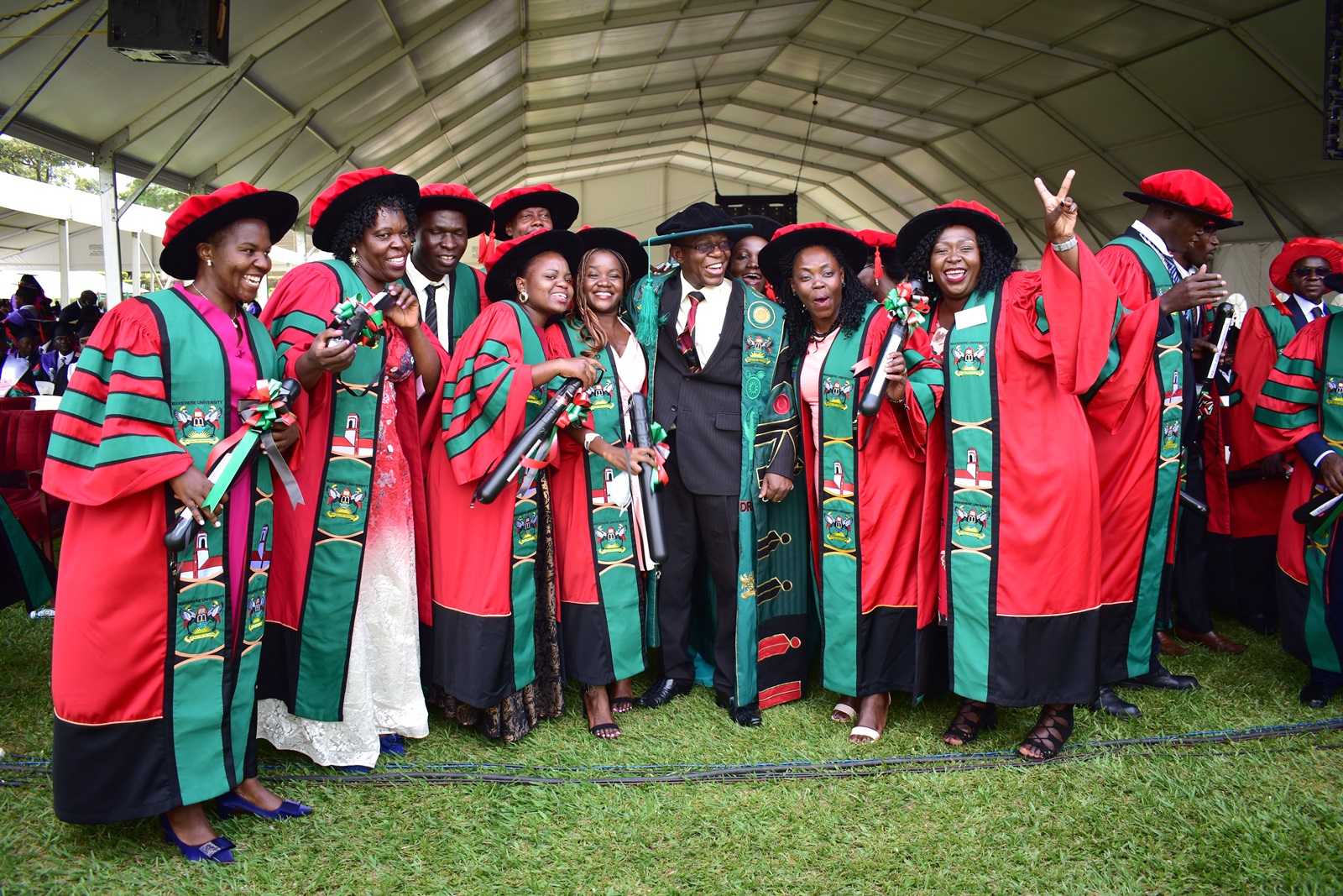 The Director, Directorate of Research and Graduate Training (DRGT), Prof. Buyinza Mukadasi (Centre Black Cap) congratulates the PhD graduands at the first session of the 72nd Graduation Ceremony of Makerere University held 23rd May 2022.