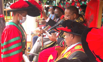 The Chancellor, Prof. Ezra Suruma (R) confers the Doctor of Laws (LL.D) of Makerere University upon Ms. Caroline Adoch (L) during Day 1 of the 72nd Graduation Ceremony held in the Freedom Square on 23rd May 2022.