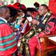 The Chancellor, Prof. Ezra Suruma (R) confers the Doctor of Philosophy upon Dr. John Kalule from CEES (L) during the Second Session of the 72nd Graduation Ceremony of Makerere University held on 24th May 2022 in the Freedom Square.