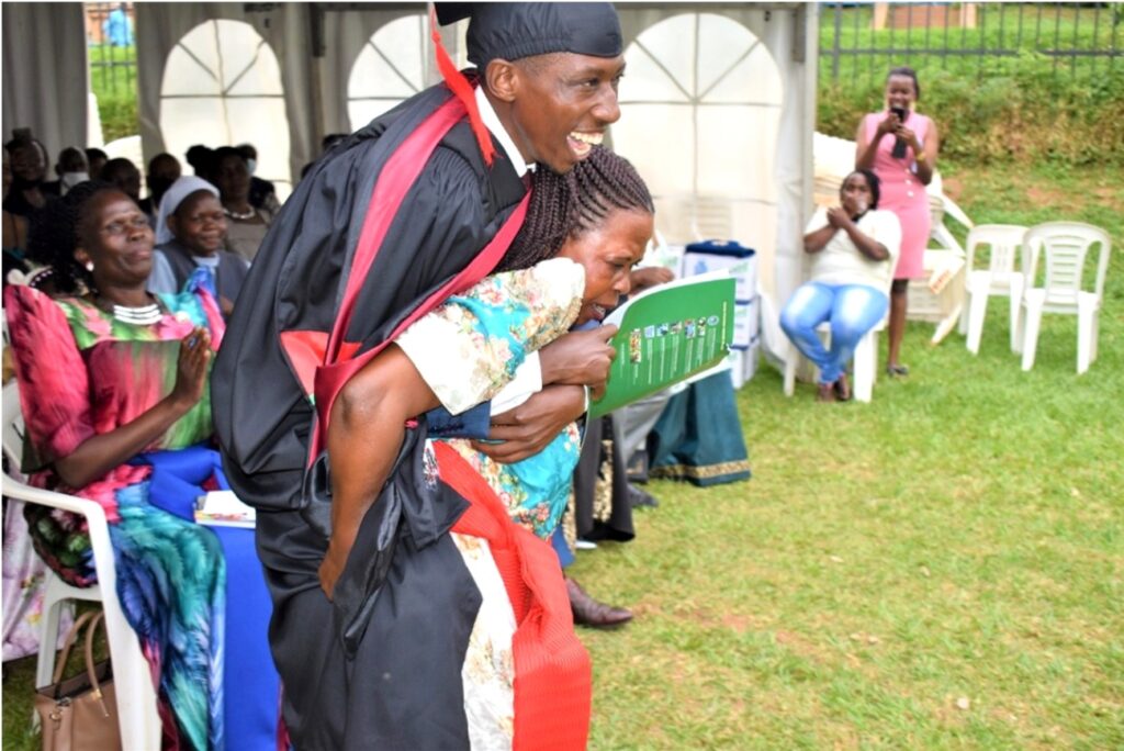 Mothers' joy! The Third Best Performing Student Wafula Ivan is carried by his Mother on her back