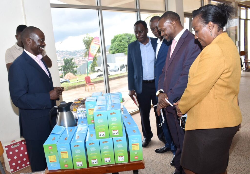 The DVCAA, Prof. Umar Kakumba (2nd R) and the Principal of CAES, Prof. Gorettie N. Nabanoga (R) tour some of the products developed under the project.