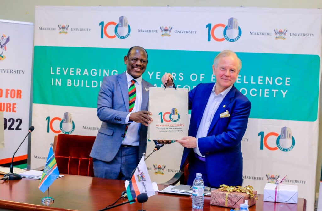 The Vice Chancellor-Prof. Barnabas Nawangwe (L) presents an assortment of Mak Souvenirs to the President of KI-Prof. Ole Petter Ottersen (R) after the meeting with Members of Management and the delegation from KI on 5th May 2022, CTF1, Makerere University.