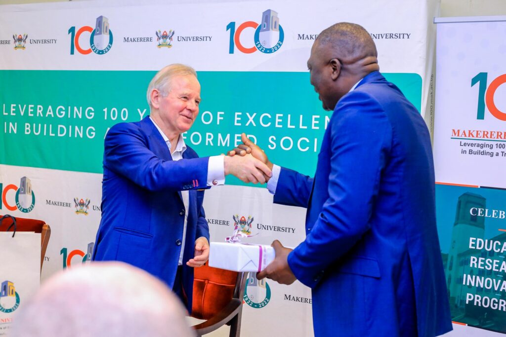 Prof. Ole Petter Ottersen (L) presents a gift to Prof. Isaac Kajja (R).