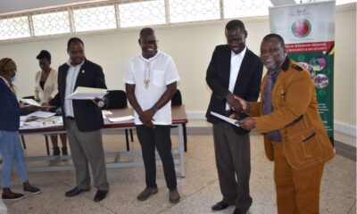Professor James Acai the Deputy Principal, College of Veterinary Medicine, Animal Resources and Bio-Security (CoVAB) (2rd Right) hands over a certificate to one of the course participants with Professor Patrick Pithua Virginia Polytechnic and State University (3rd R) and Prof. Lawrence Mugisha from CoVAB (3rd L).