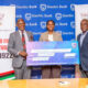 The Vice Chancellor, Prof. Barnabas Nawangwe (L) and CEO & Head Mak@100 Secretariat, Mr. Awel Uwihanganye (R) receive the dummy cheque of UGX 150 Million from Ms. Anne Juuko, CEO, Stanbic Bank Uganda on 18th May 2022.