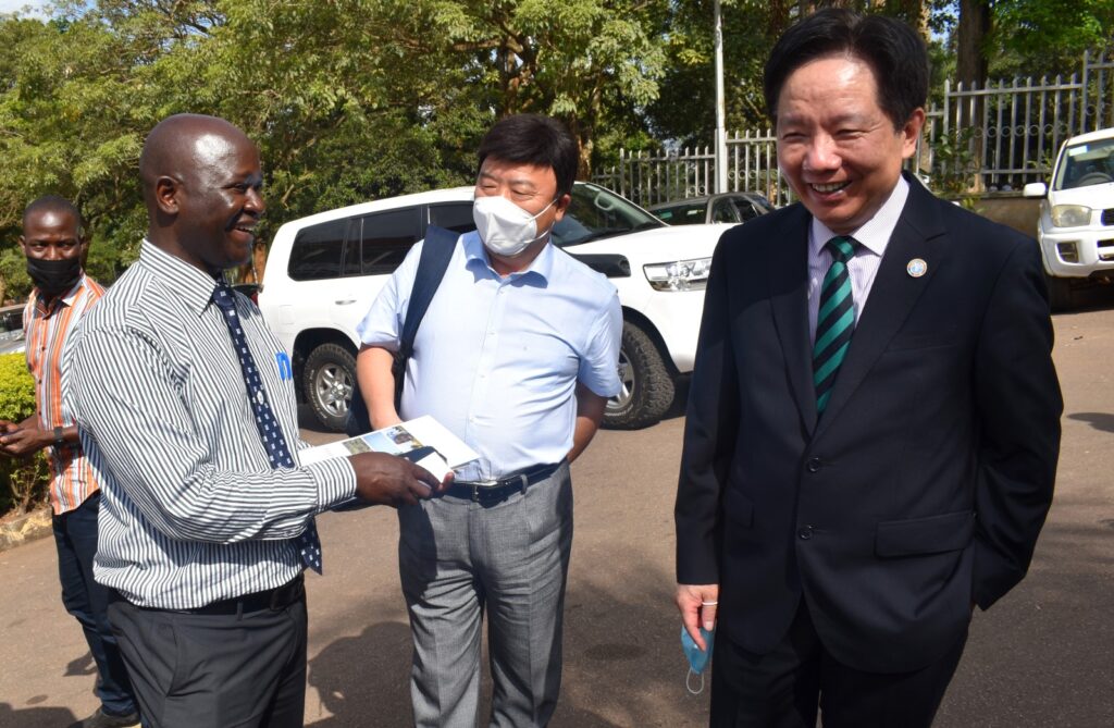 Prof. Bamutaze (L) sharing a light moment with Mr. Anping Ye (R) and Dr. Lui Zhongwei from FAO (C) after the opening ceremony.