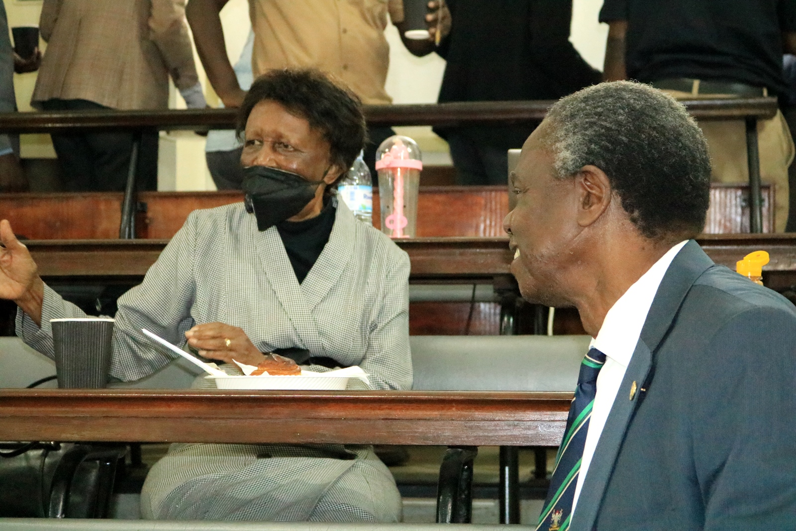 Professor Josephine Namboze (L) and Professor Francis Omaswa (R) chat during HEPI-ACHEST Health Professions Education Symposium held 17th June 2022 at Makerere University.