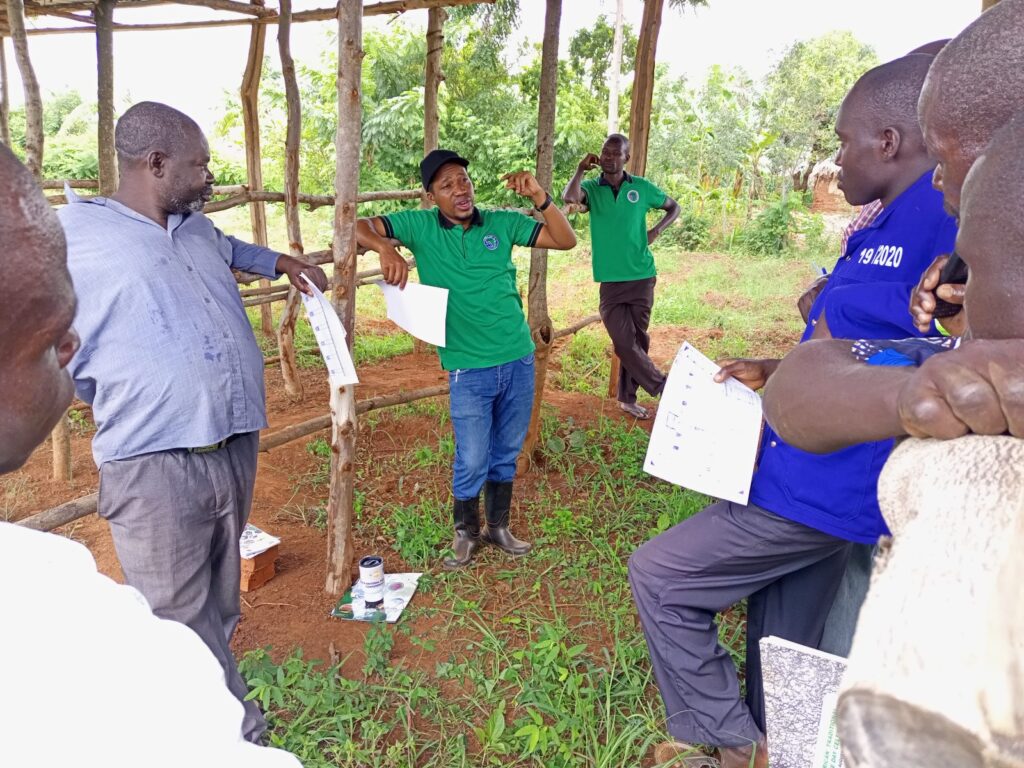 AFRISA Programme Officer for Dairy Industry and Business, Mr. Israel Baguma in a meeting with trainees of the dairy value chain at the demonstration site in Kaberekeke village, Butebo District on 17th May, 2022. 