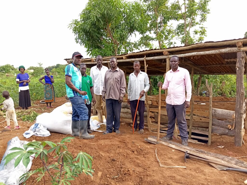 AFRISA Piggery Industry and Business Programme Officer, Mr. Jolly Bwiire Muchere (1st left) together with piggery value chain trainees pose for a photo at one of the piggery demonstration sites in Petete village on 19th May, 2022.