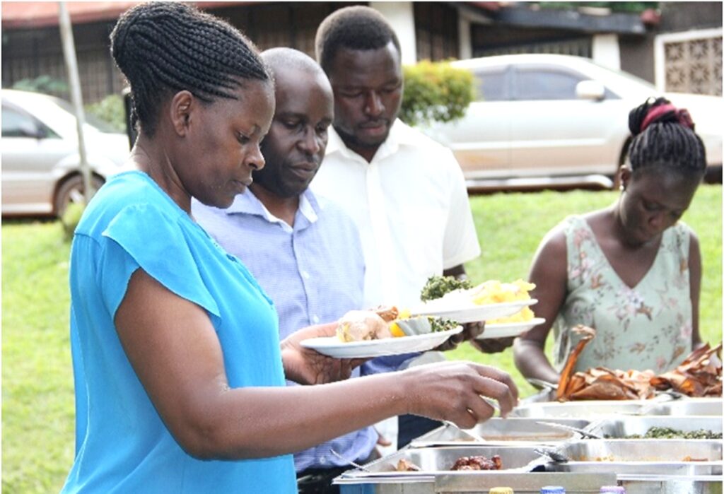 GMD staff and members of Ms. Frances Nyachwo's family enjoying the dinner