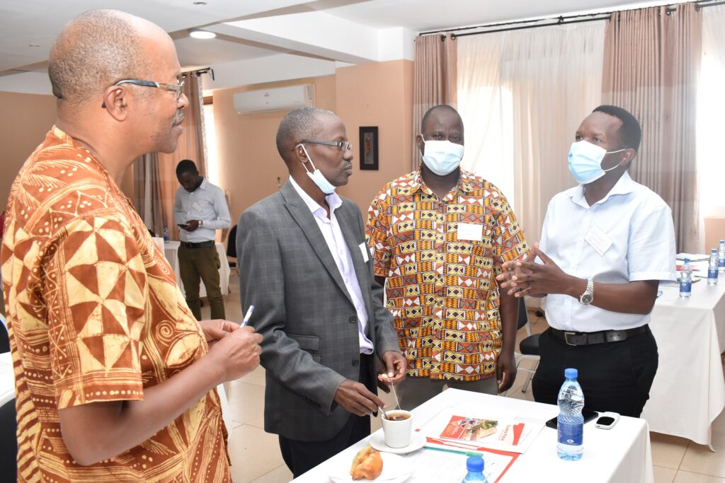 CAES staff chatting with Mr. Erongu (R) at the workshop.