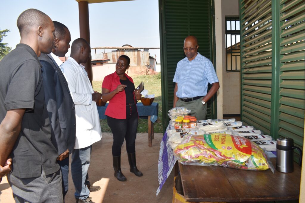 The Principal, Prof. Gorettie Nabanoga (2nd R) checking out some of the products made from soybean at MAKCSID.