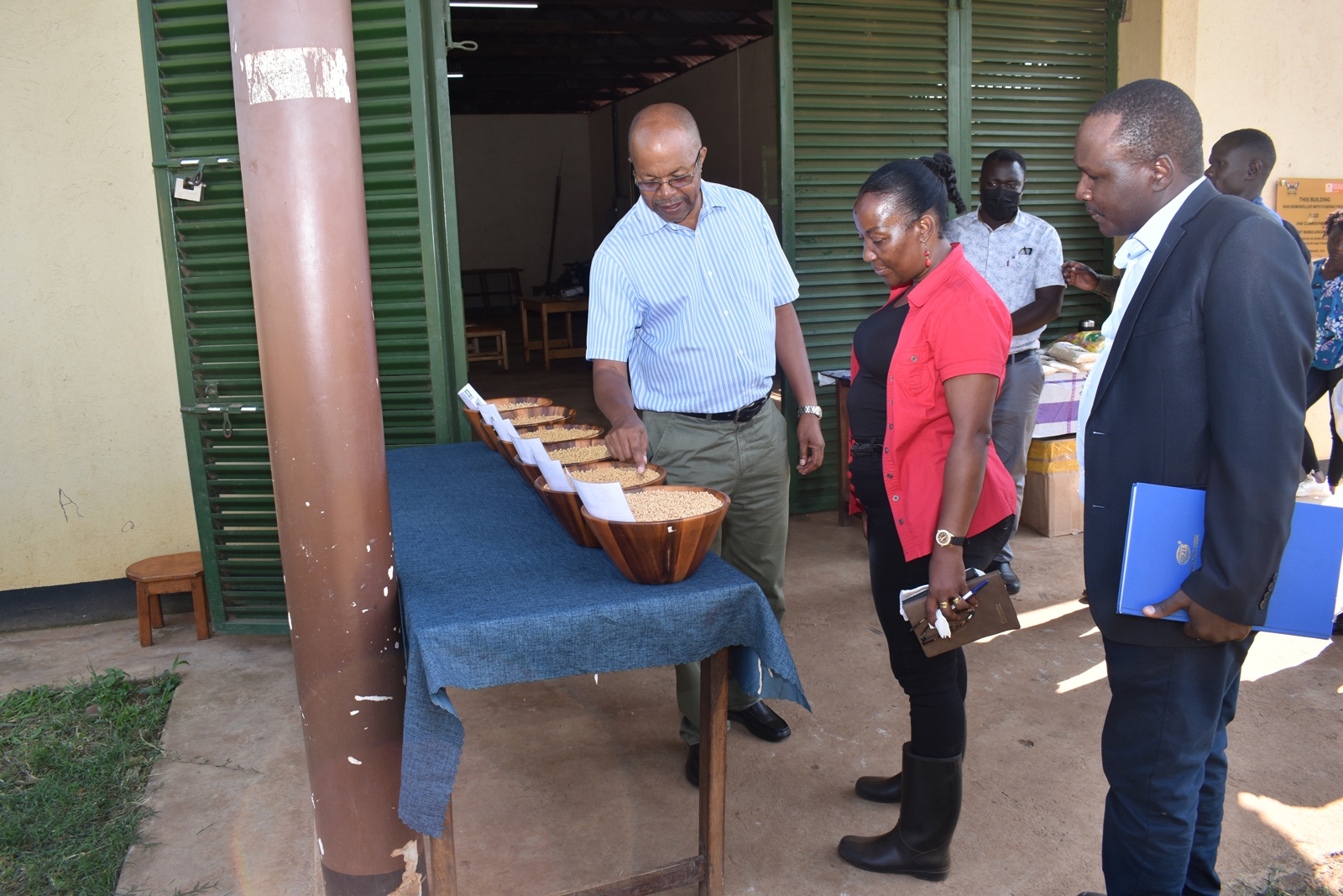 Prof. Tukamuhabwa shows the Principal the varieties of soybean seed bred at MAKCSID, 6th July 2022, MUARIK, CAES, Makerere University.