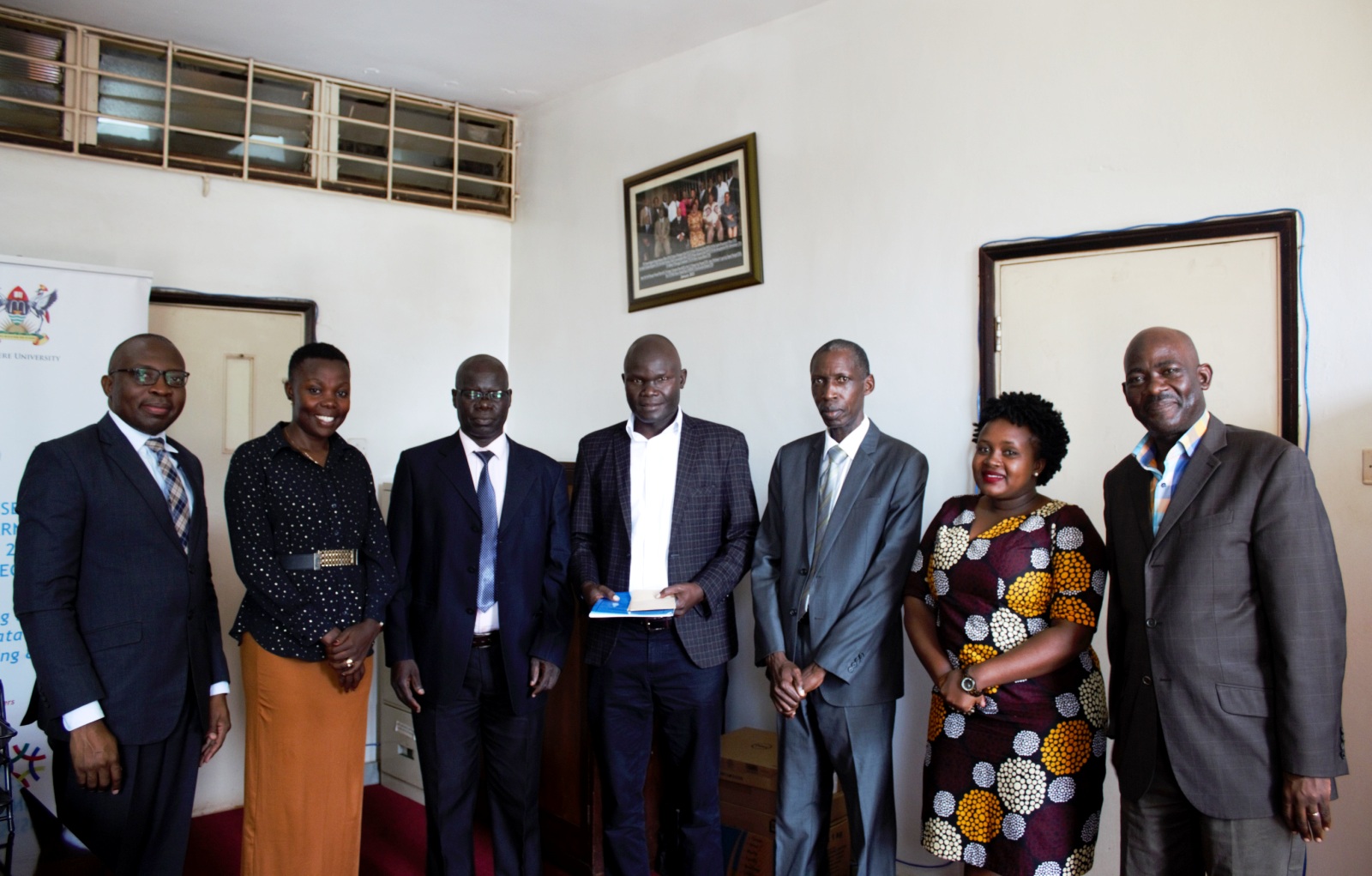 The Principal CEES-Prof. Muwagga Mugagga (3rd R), Deputy Principal CEES-Dr. Ronald Bisaso (L), outgoing Head, Department of Adult and Community Education (DACE)-Dr. Willy Ngaka (3rd L), Incoming Head, DACE-Dr. Rahman Sanya (C) and other officials at the handover ceremony on 30th June 2022, Makerere University.