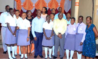 Dr. Jonathan Mayito (3rd L) and Richard Kwizera (4th R) pose with students and staff of Midland High School-Kawempe after an engagement. Photo: THRiVE CPE Newsletter | July 2022.
