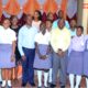 Dr. Jonathan Mayito (3rd L) and Richard Kwizera (4th R) pose with students and staff of Midland High School-Kawempe after an engagement. Photo: THRiVE CPE Newsletter | July 2022.
