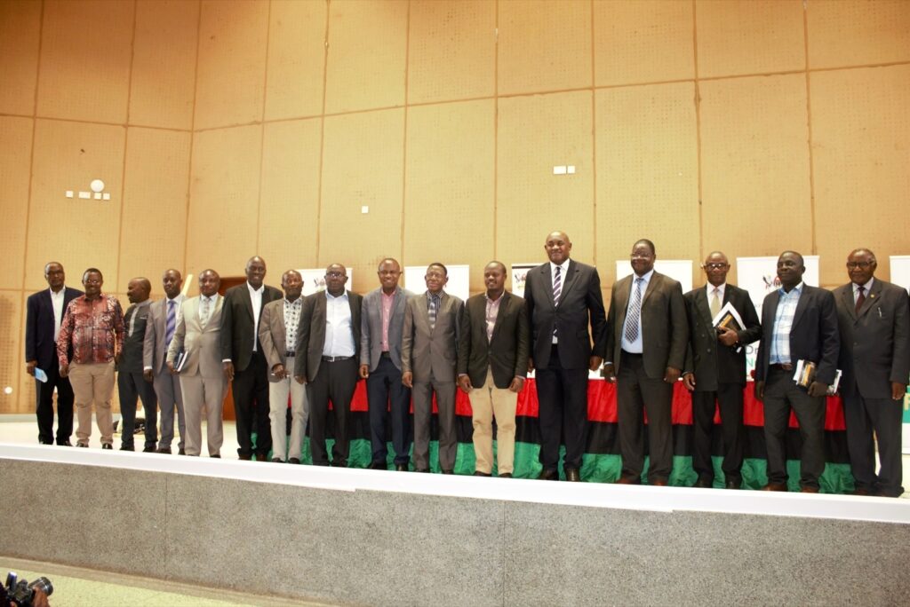 Hon. Chris Baryomunsi (5th R) poses with officials and some of the authors at the Book Launch on 29th July 2022, Yusuf Lule Central Teaching Facility Auditorium, Makerere University. 