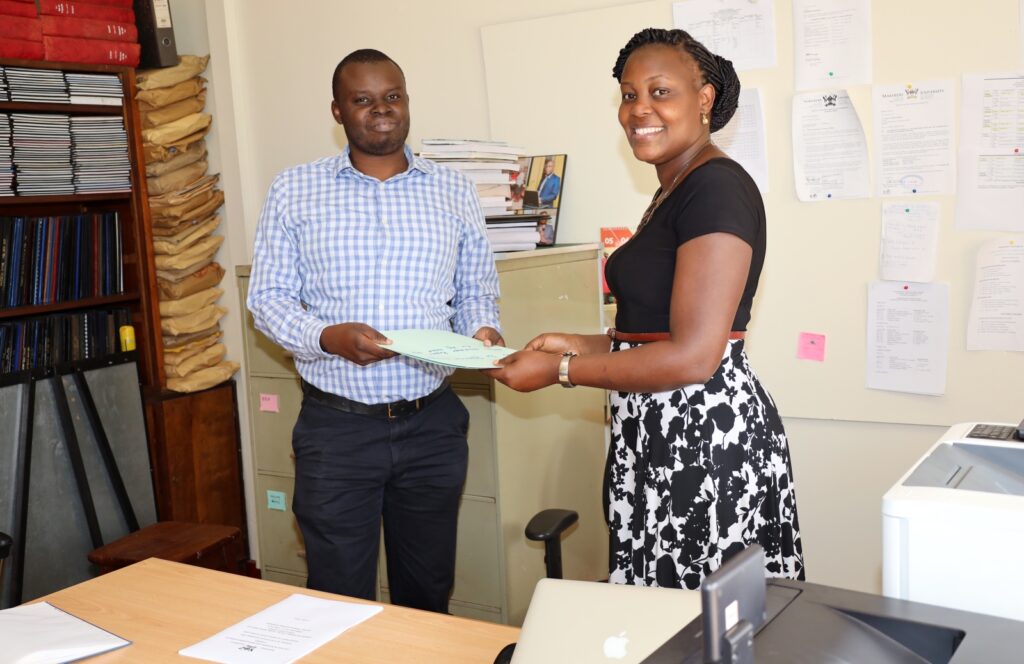 The outgoing Head of the Department of Population Studies, Dr. Stephen Ojiambo Wandera (L) and incoming Head, Dr. Patricia Ndugga (R) during the handover event. 